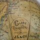 Globe on turned and blackened wooden base