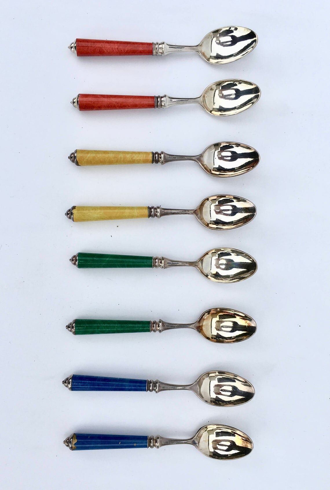 Set of eight enamelled silver spoons