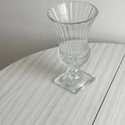 Antique thick glass vase on a pedestal.
