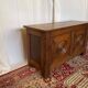 Small antique oak chest with carved panels.