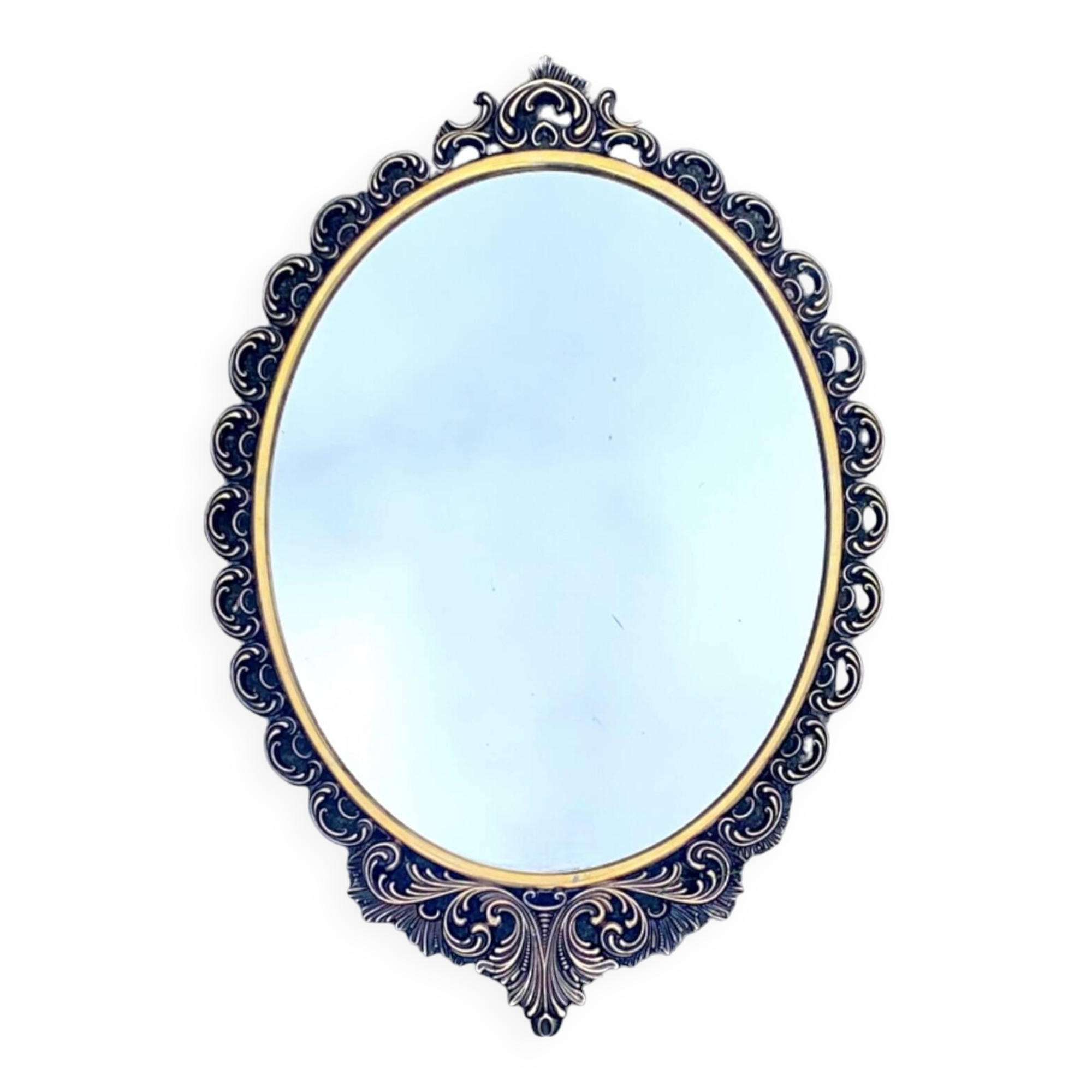 Old oval wall mirror in gilded brass