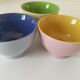 Set of three pastel two-tone mini bowls in glazed ceramic.