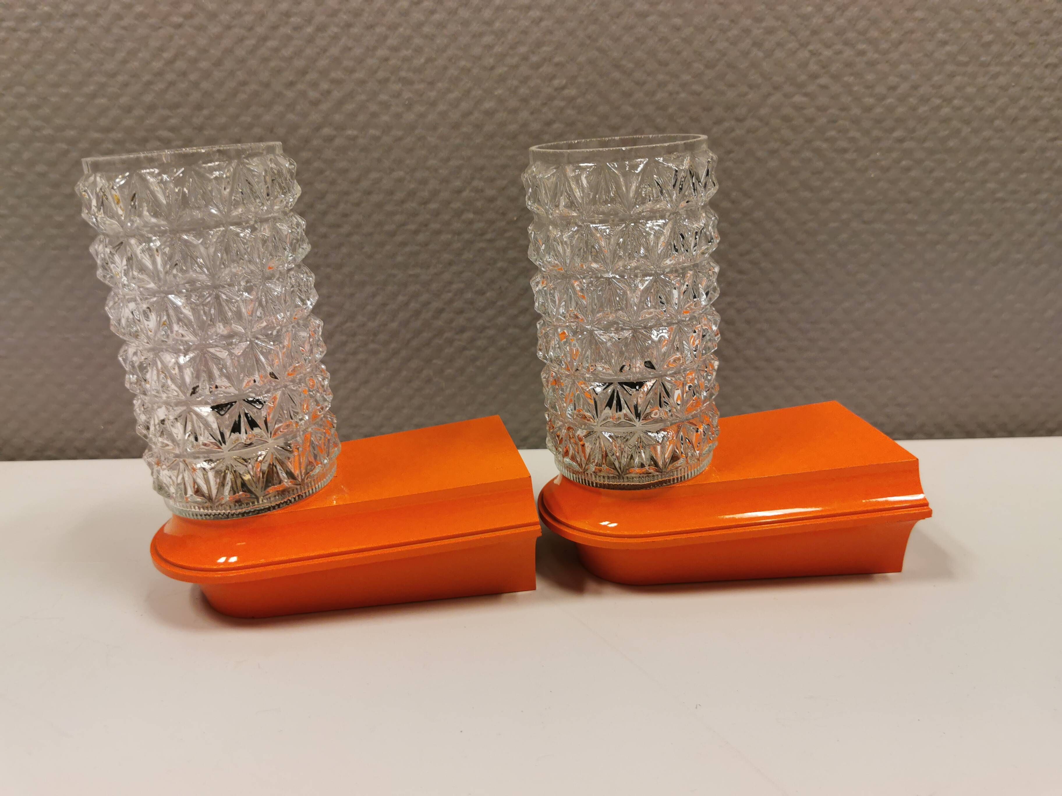 Bathroom lamps in a nice orange colour with a crystal glass shade and a base of hard thin plastic