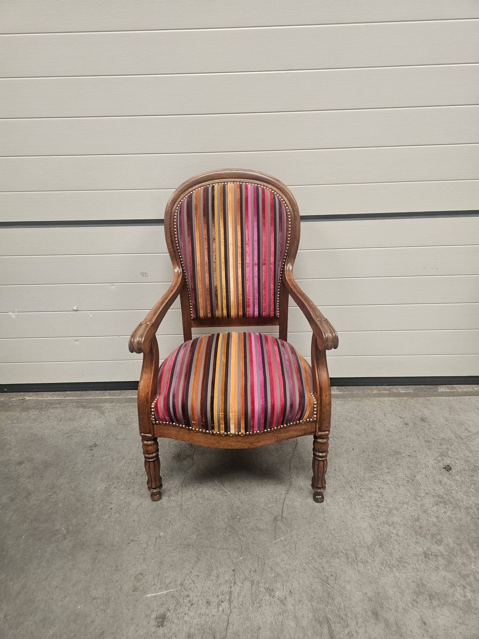 Antique striped multicoloured velvet armchair with turned legs.