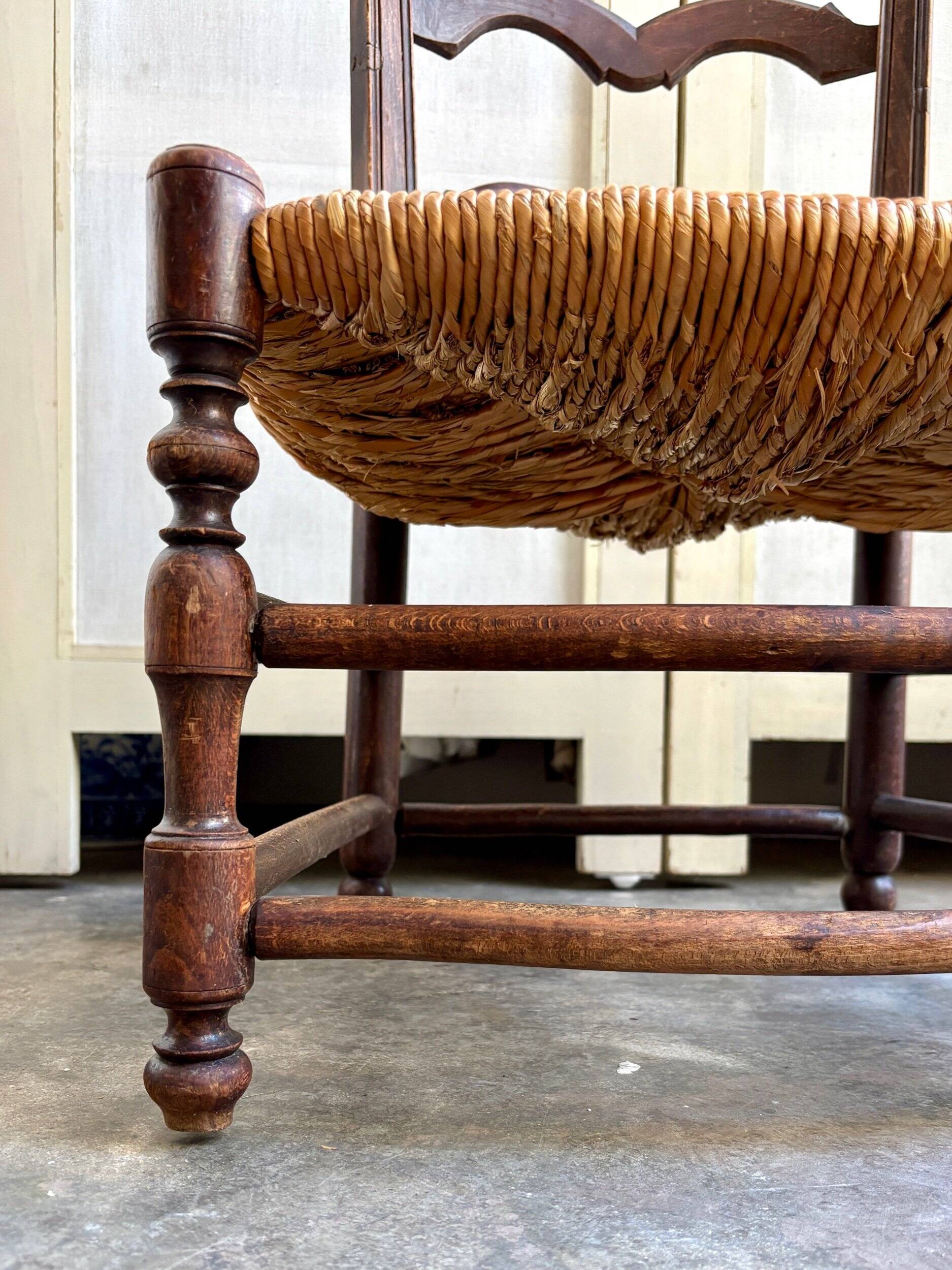Low Provencal chair in dark wood and woven straw
