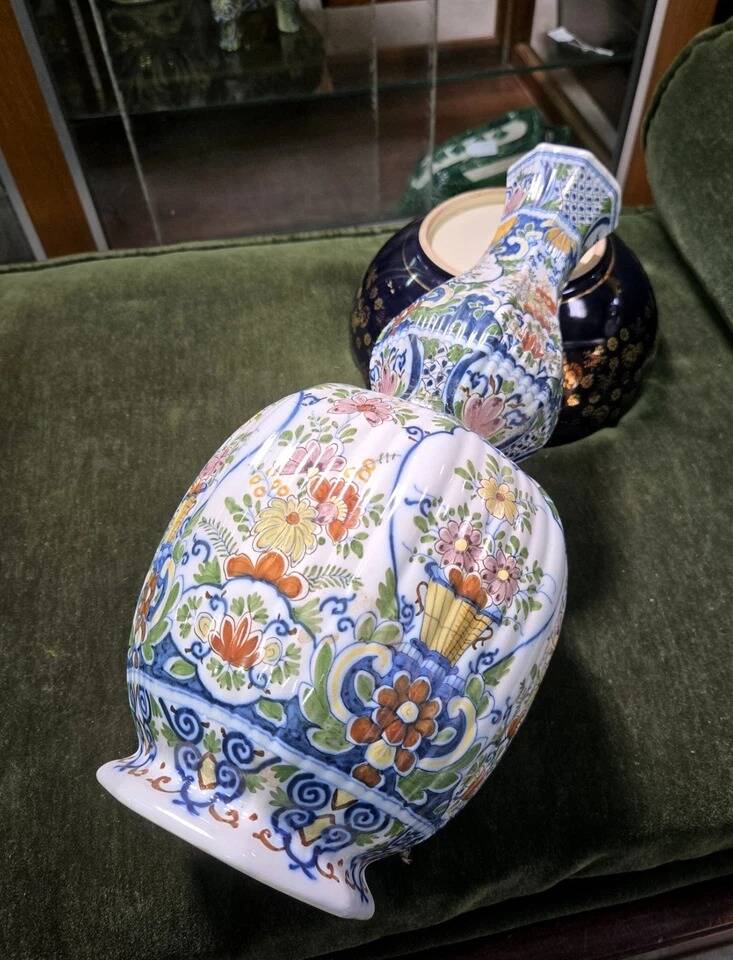 Large earthenware vase with a baluster body and elongated neck, richly decorated.