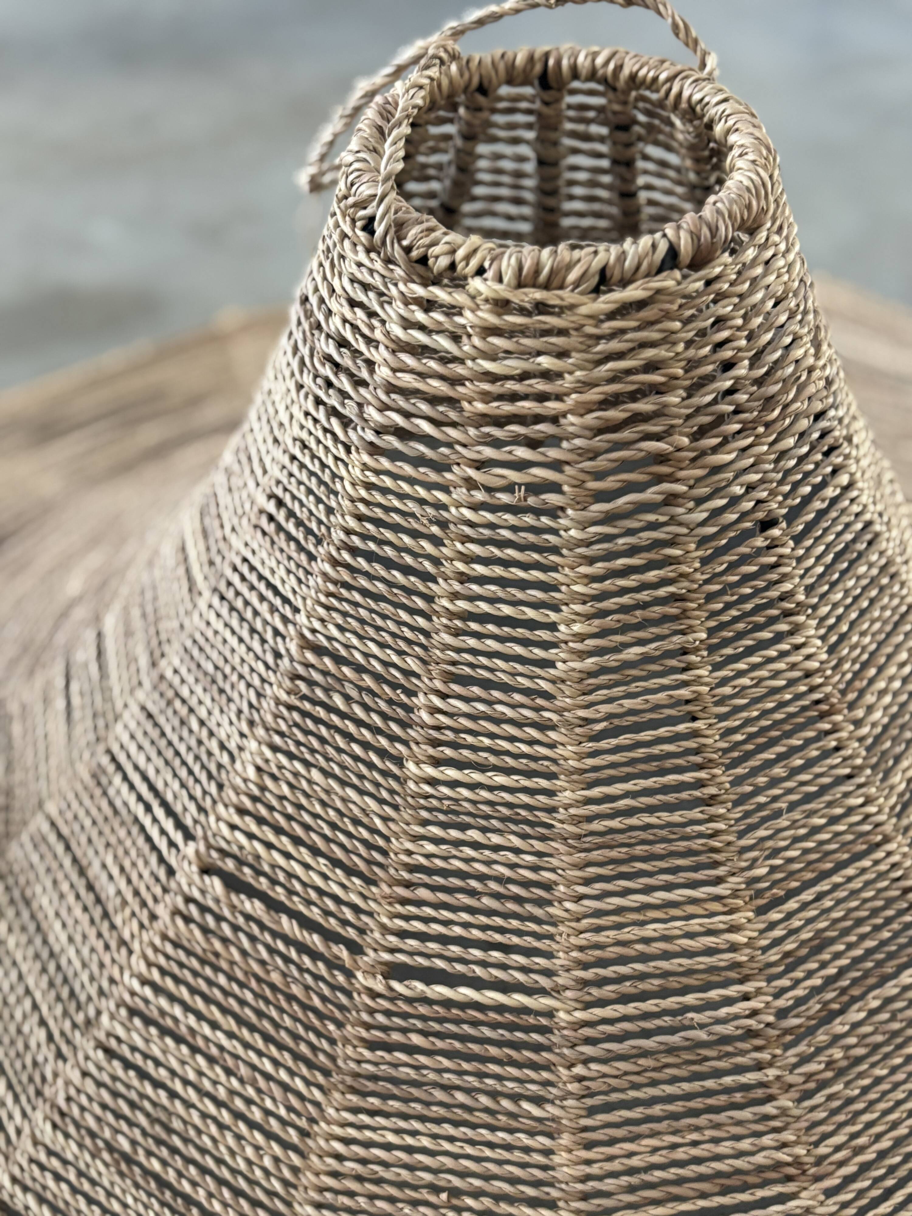 Large lampshade made of woven ropes.