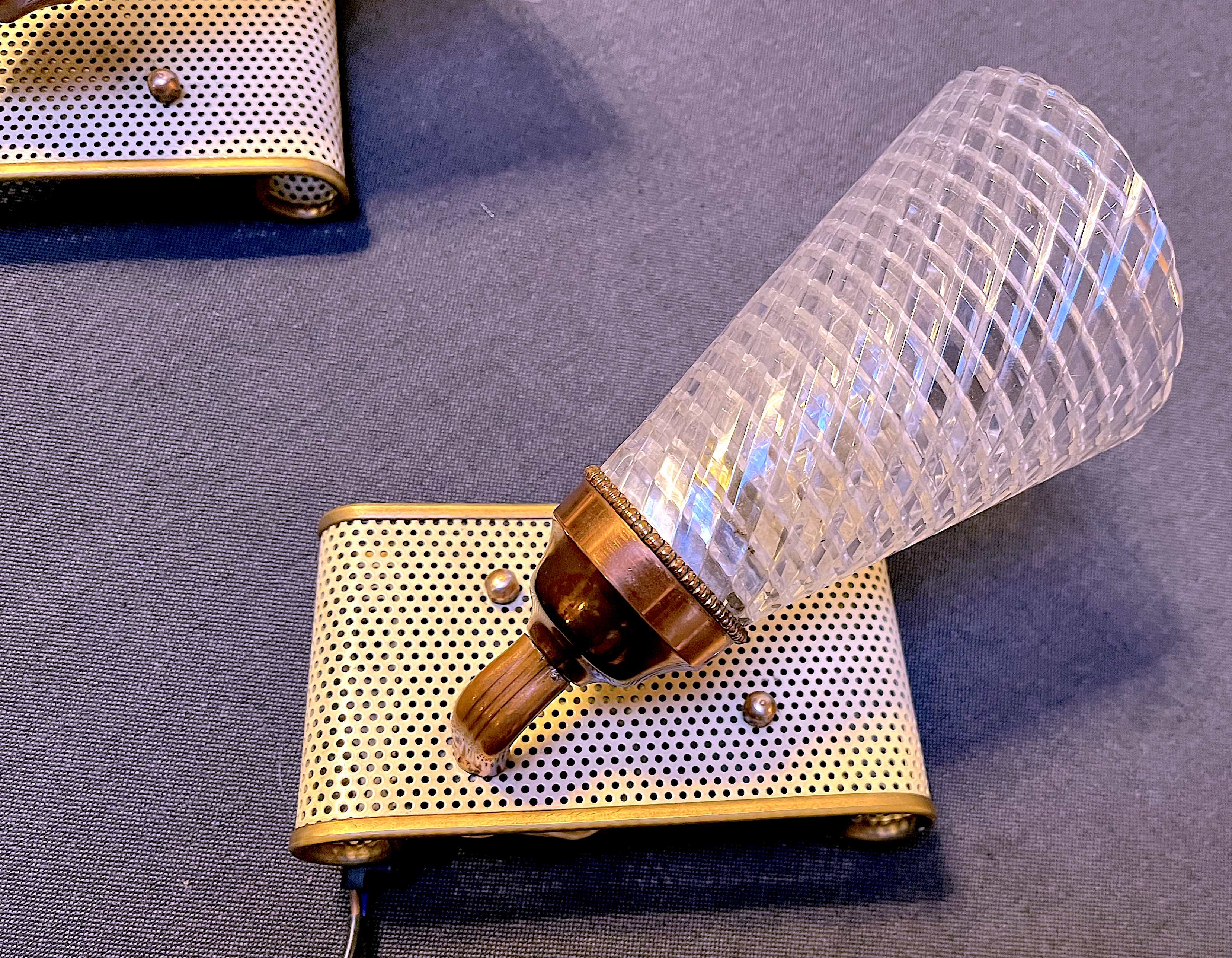 Pair of brass sconces, perforated metal and perhapx conical lampshade, France 50's