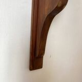 Antique wall shelf with a scalloped edge.