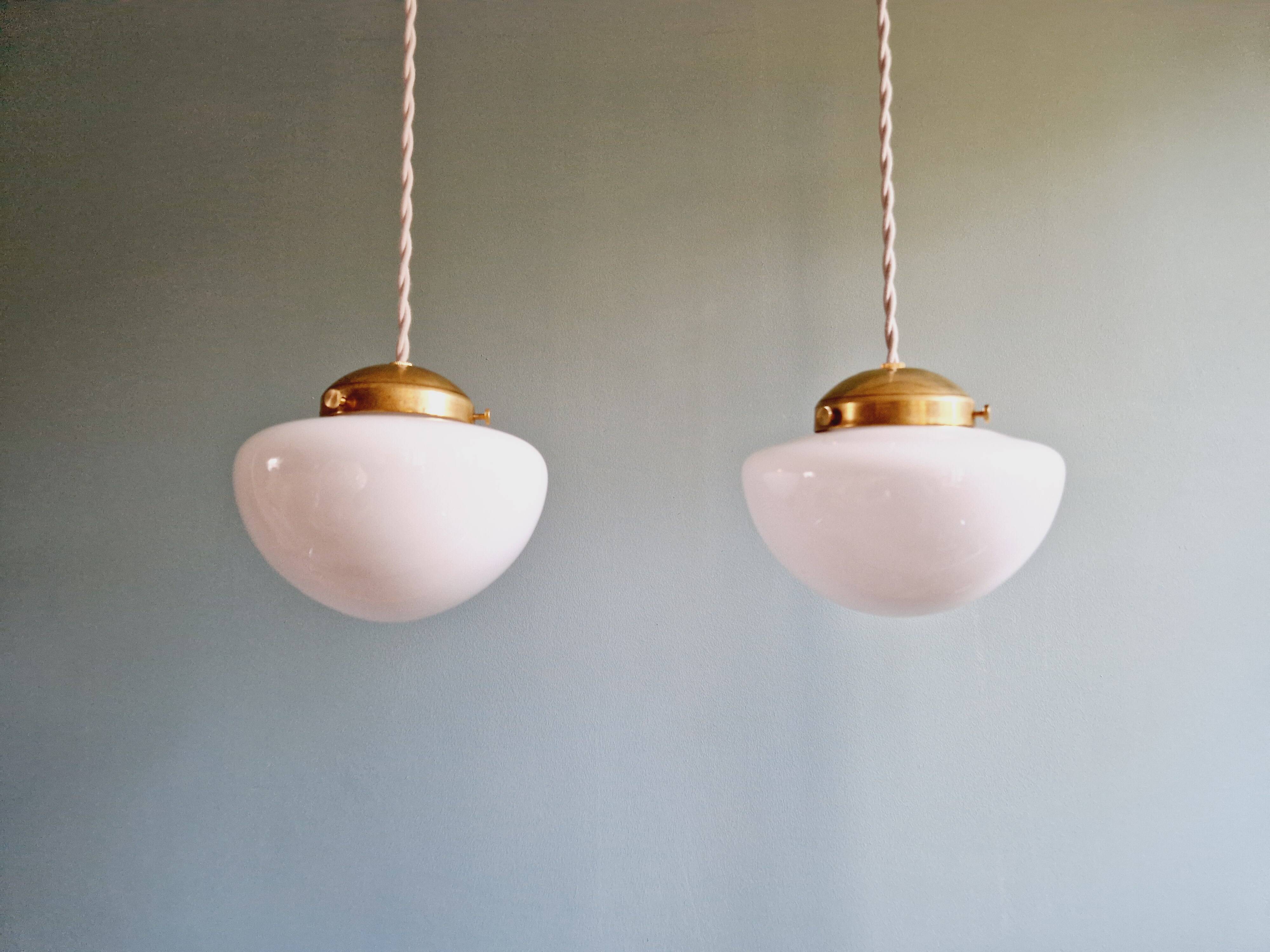 Duo of Art Deco suspensions in white opaline, 1920s-30s