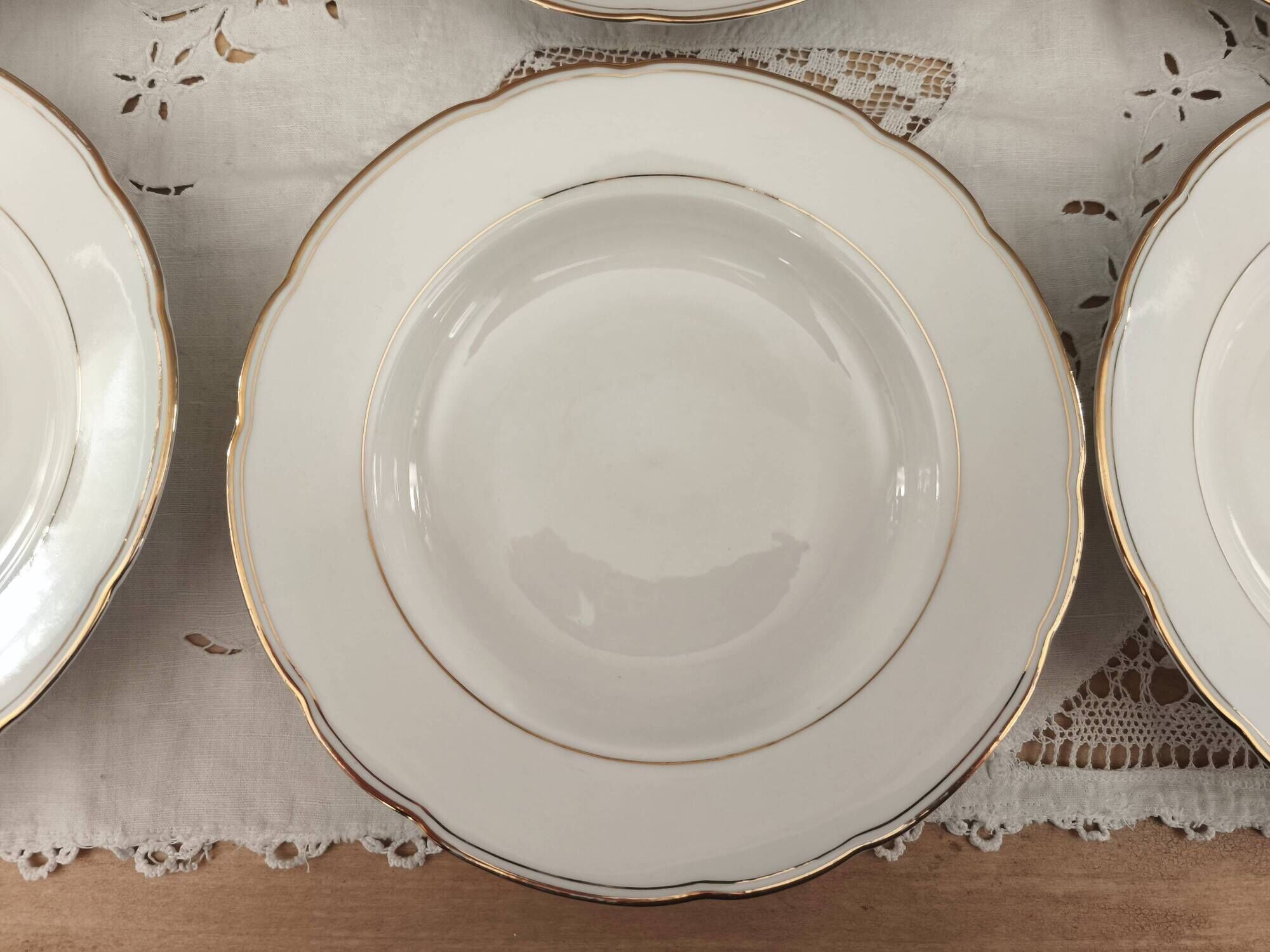 Set of 6 deep plates in fine porcelain from Bohemia with a gold rim.