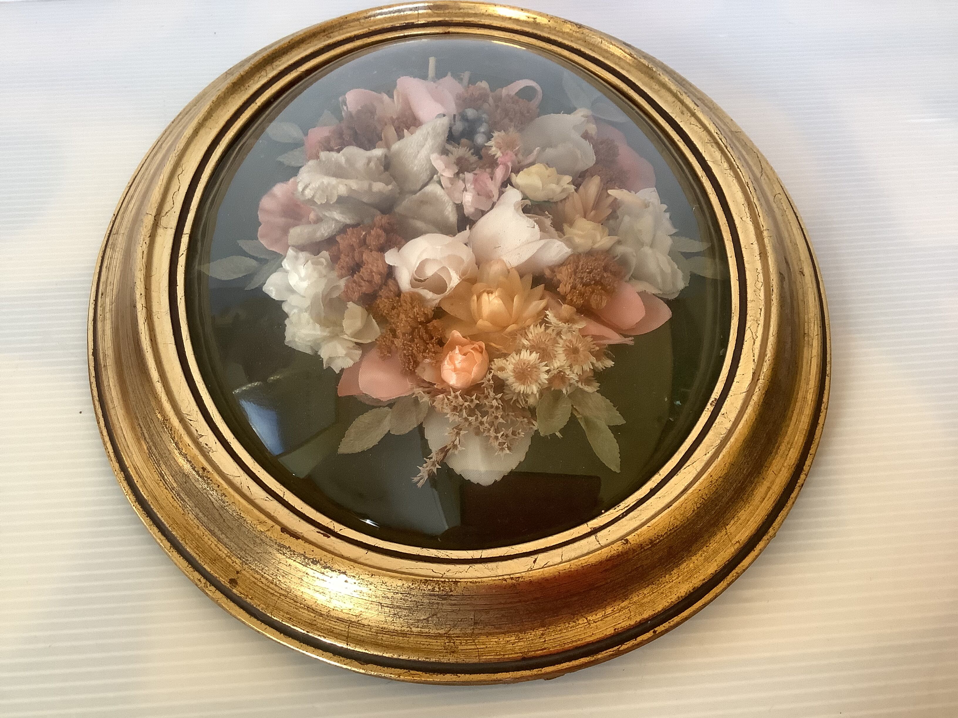 Golden oval frame dried flowers