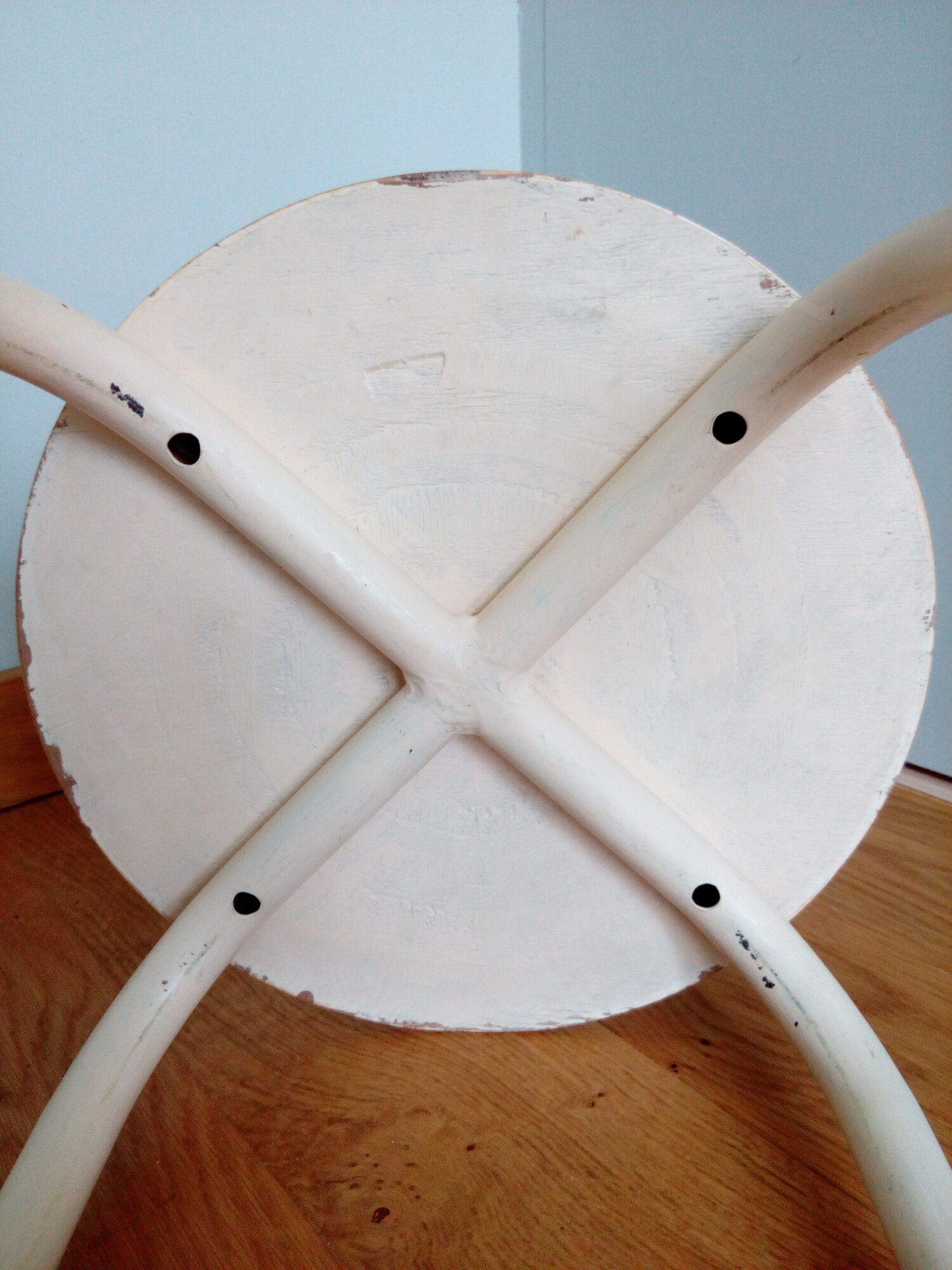 Industrial tubular metal stick sitting round in wood