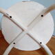Industrial tubular metal stick sitting round in wood