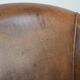 Club chair made of sheepskin leather finished with decorative nails