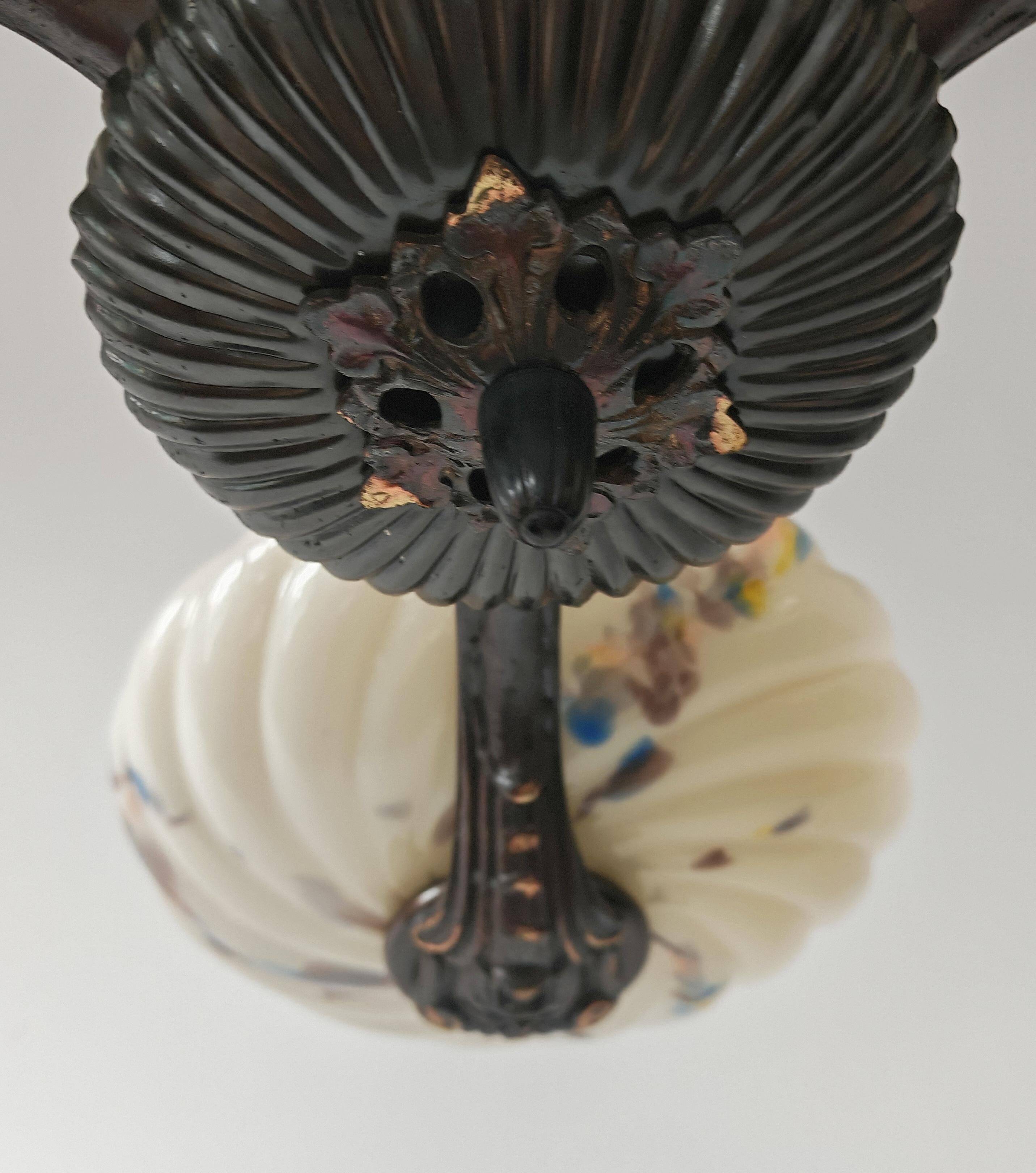 Art Deco bronze three-arm chandelier with marbled glass shades.