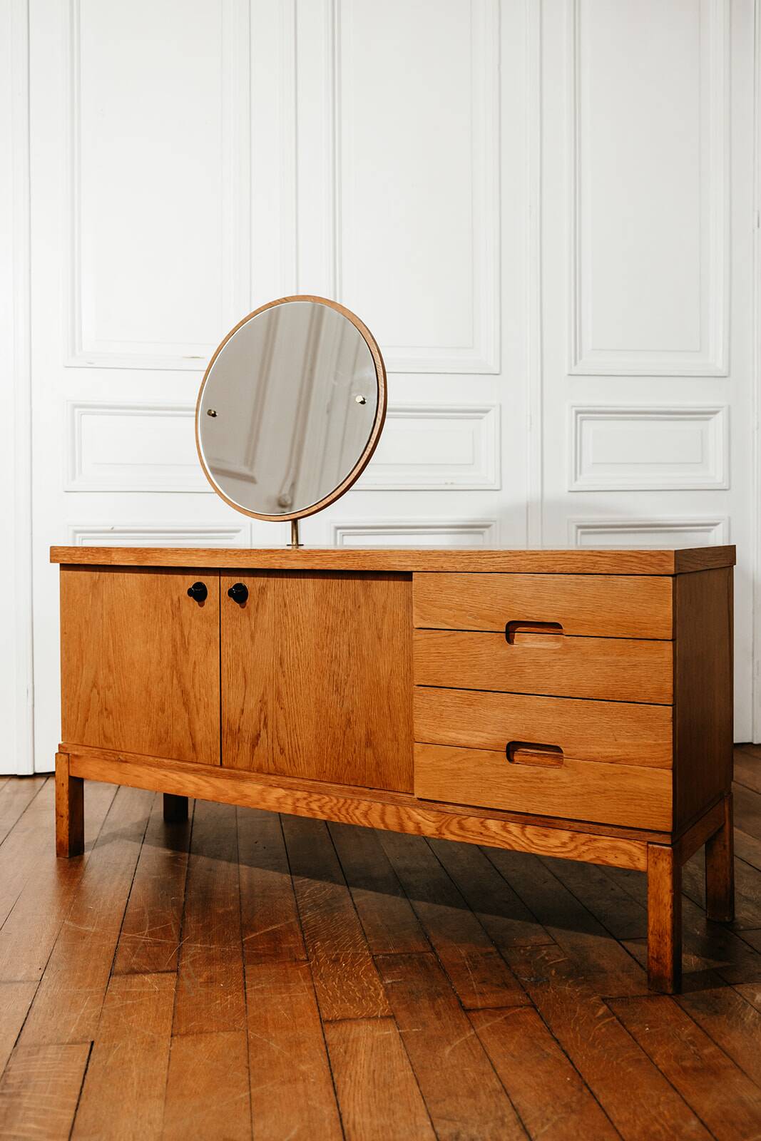 Vintage oak cabinet with circular mirror, 1960s modernist design.
