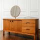 Vintage oak cabinet with circular mirror, 1960s modernist design.