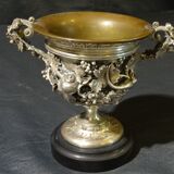 Carved silver bronze vase mounted on marble pedestal