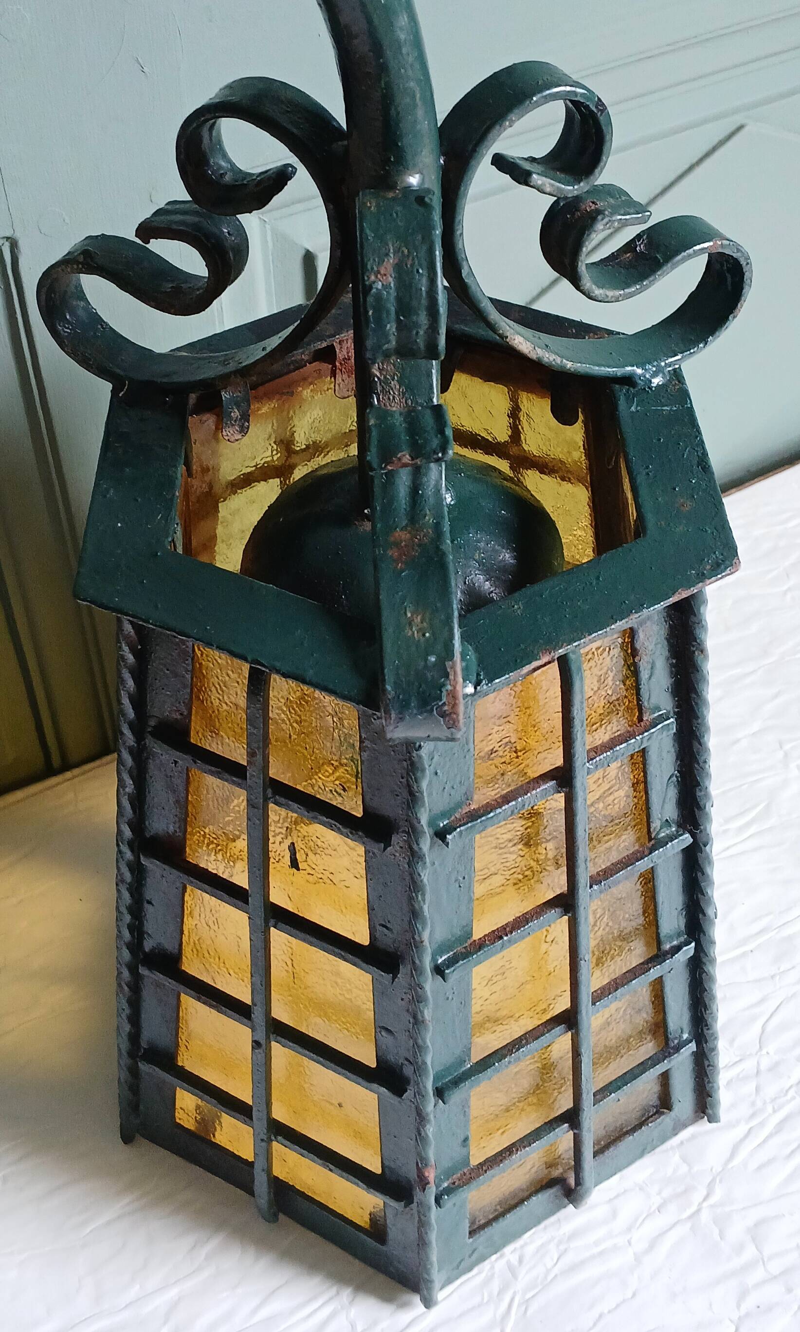 Wrought iron wall lantern & amber cathedral glass