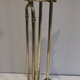 Neoclassical brass fire accessory with duck head decorations.