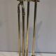 Neoclassical brass fire accessory with duck head decorations.