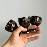 3 black ceramic egg cups with floral patterns