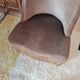 Brown velvet crapaud armchair with fringes and sculpted legs.