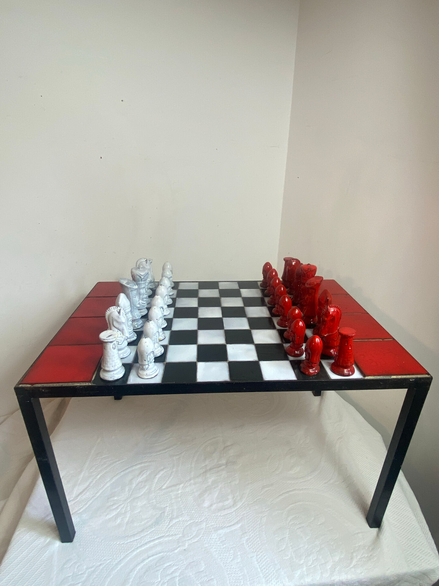 Chess set with ceramic board and pieces.