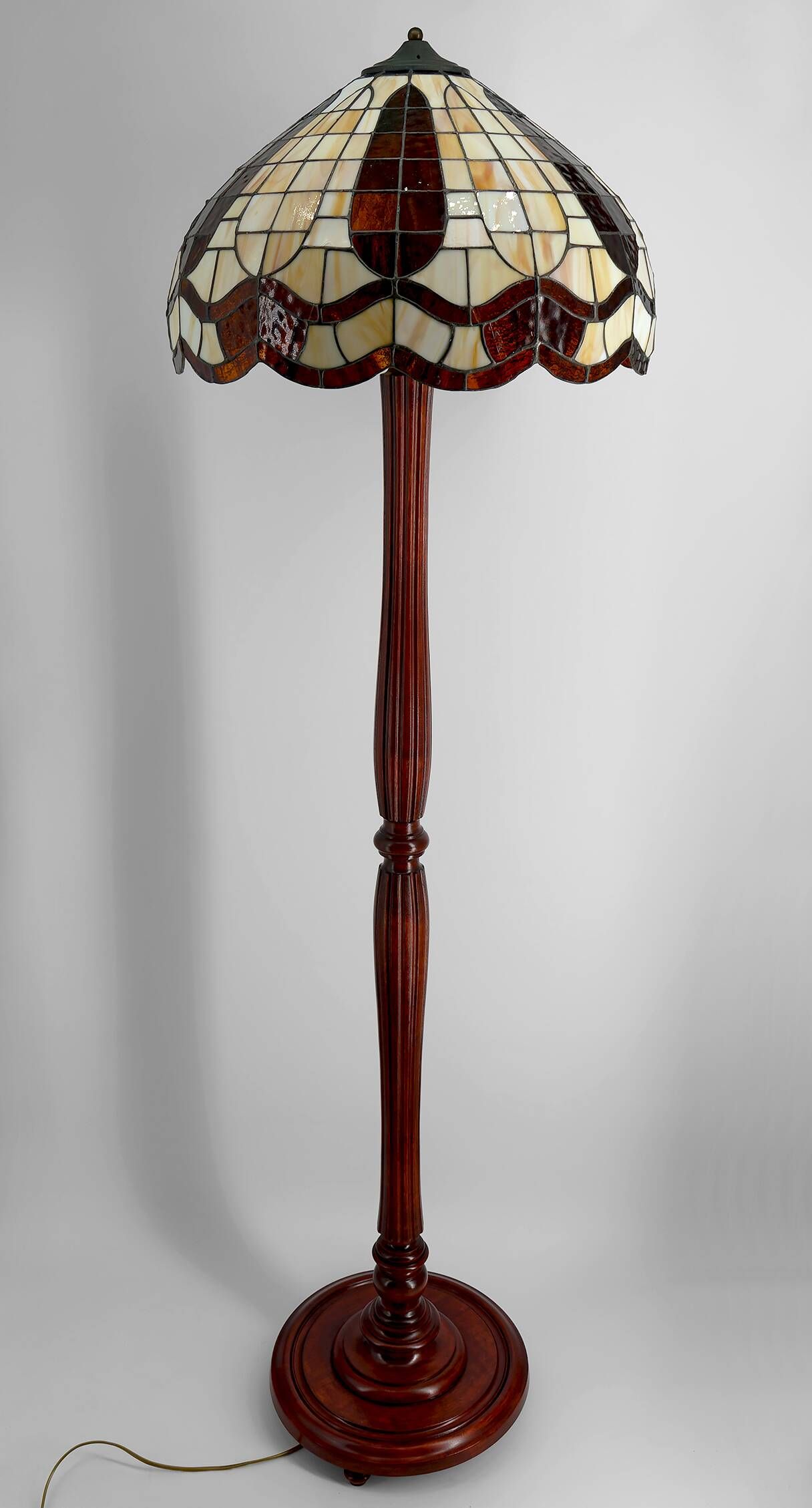 Art Deco floor lamp in carved walnut, stained glass shade, France, c. 1920