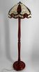 Art Deco floor lamp in carved walnut, stained glass shade, France, c. 1920