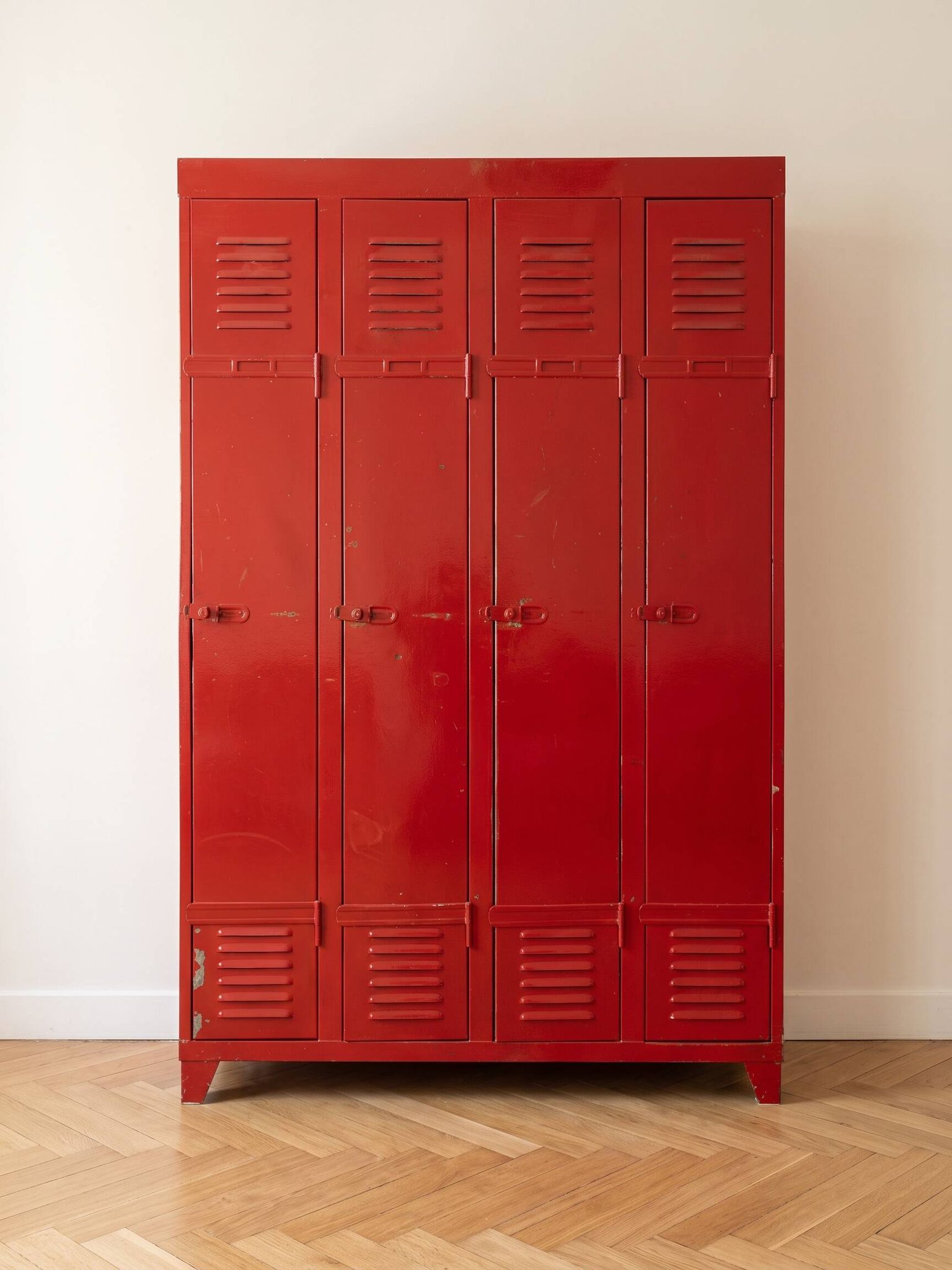 Vintage industrial wardrobe with 4 metal doors in red.