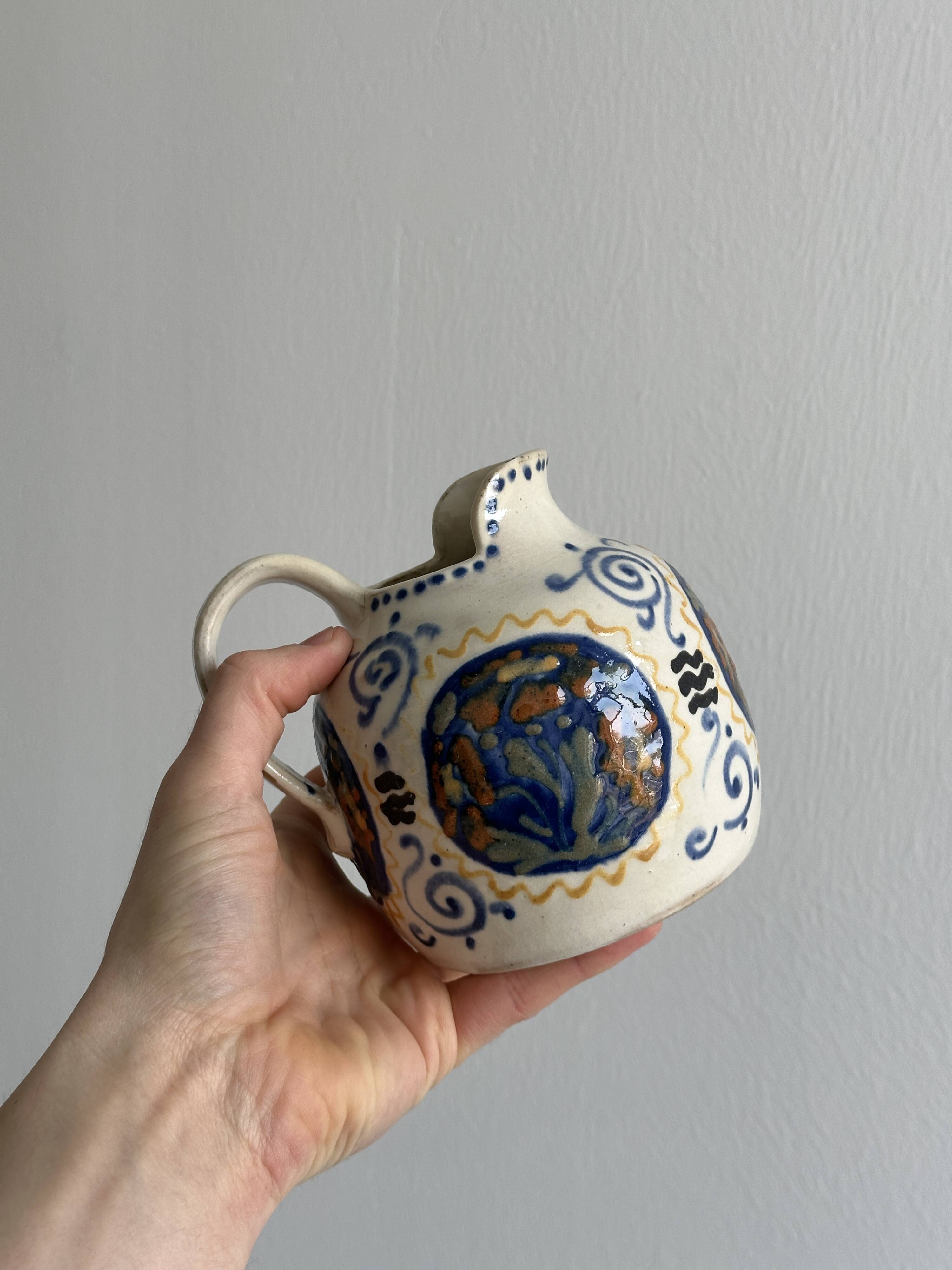 Hand painted ceramic decorative pitcher