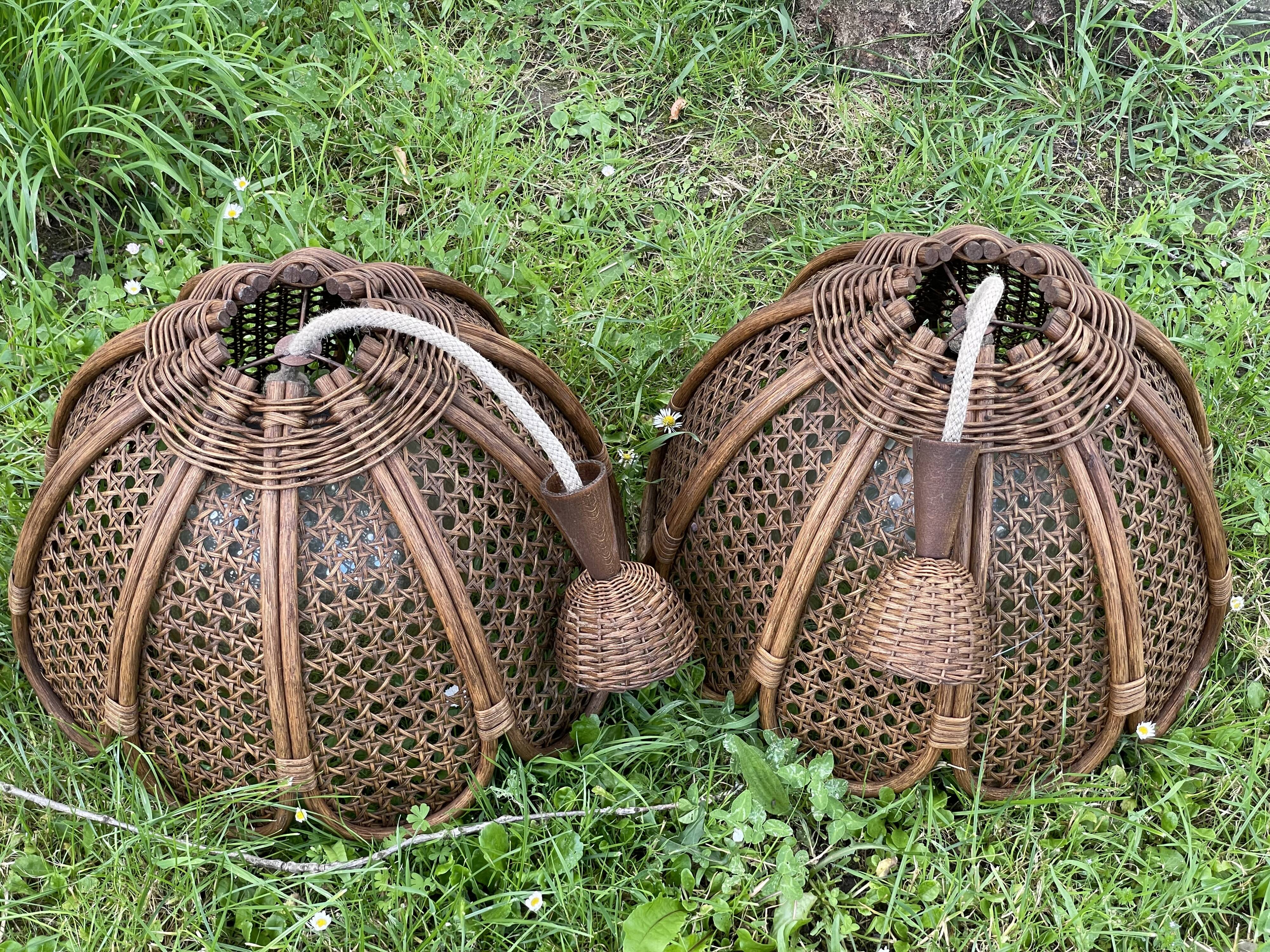 Duo of rattan and glass chandeliers