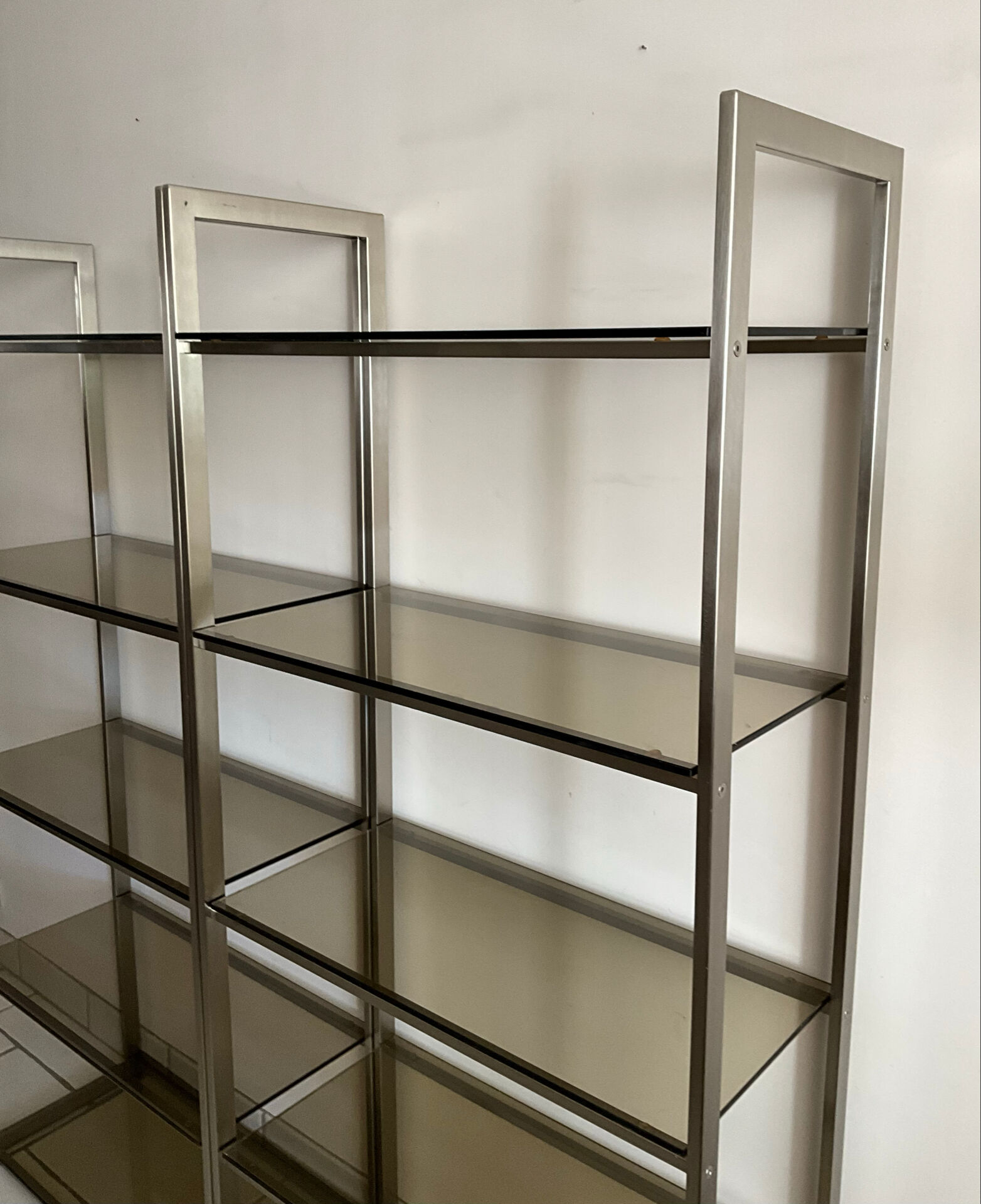 Pair of Artelano bookshelves in anodised metal and smoked glass, 1970s.