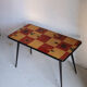 Vintage coffee table in laminate with geometric design, with tapered legs.