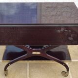 Chic serving table on wheels from the 60s with brass decorations and two shelves.