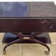 Chic serving table on wheels from the 60s with brass decorations and two shelves.