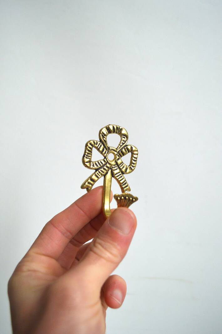 Trio of brass coat hooks