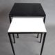 Pair of modernist nesting tables in black metal and white and black opaline 1960.