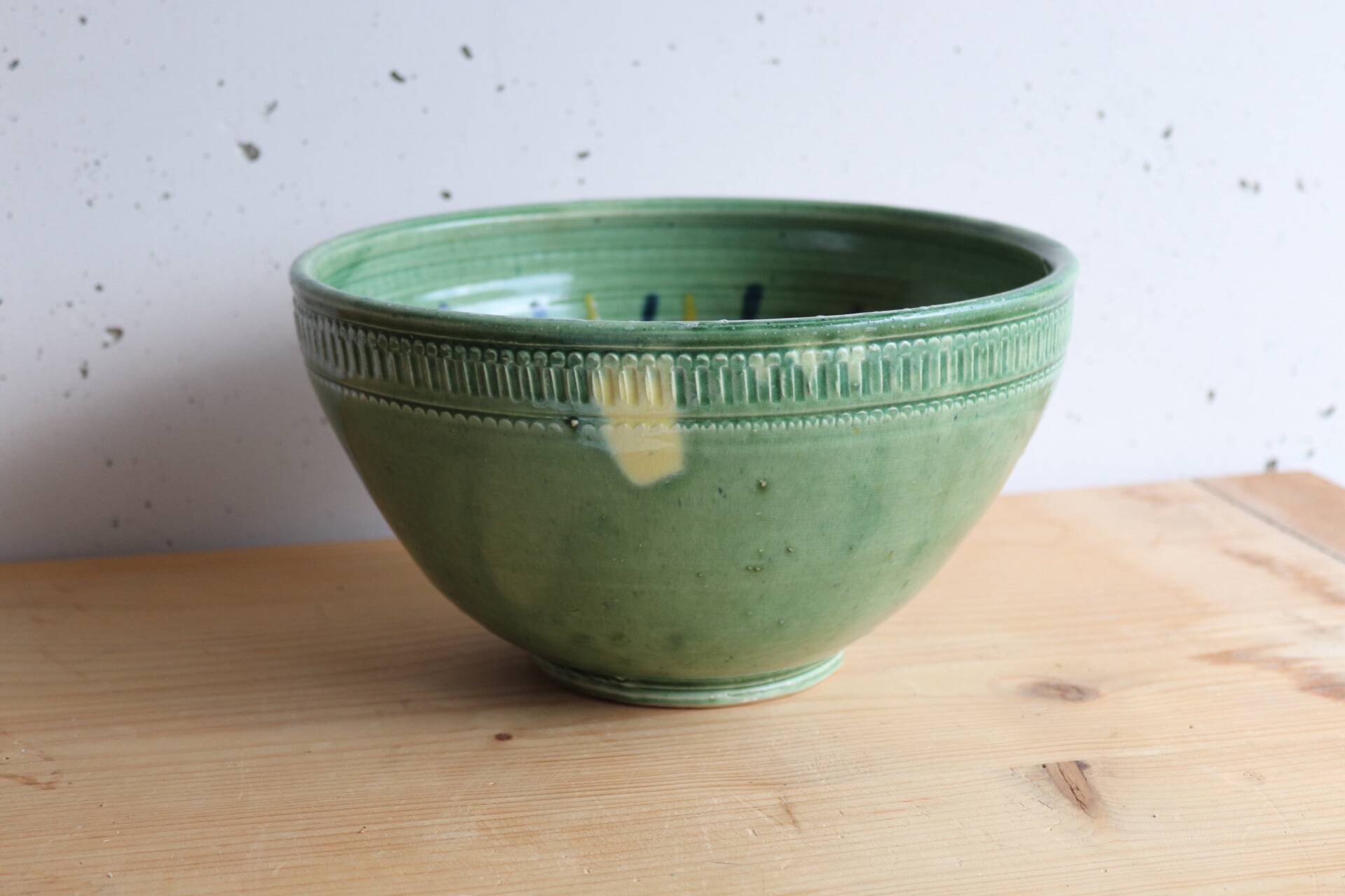 Large glazed ceramic salad bowl with a floral design.