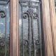 Oak entrance door and its frame and transom, wrought iron gates