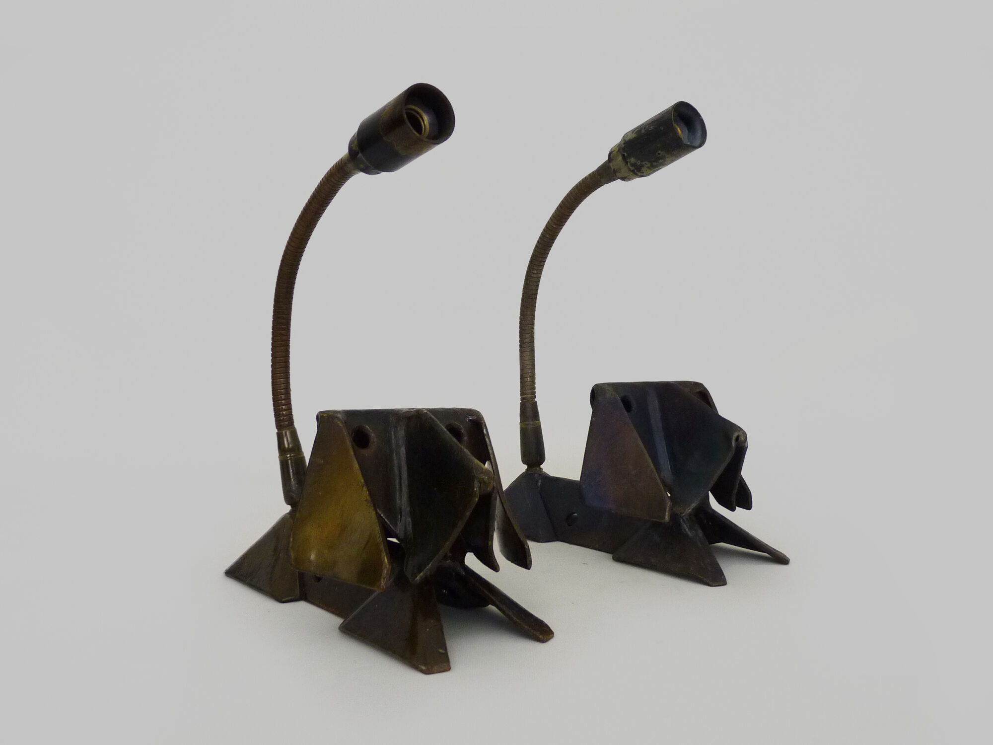 Pair of cast iron wall sconces with articulated arm, dog shape. Vintage
