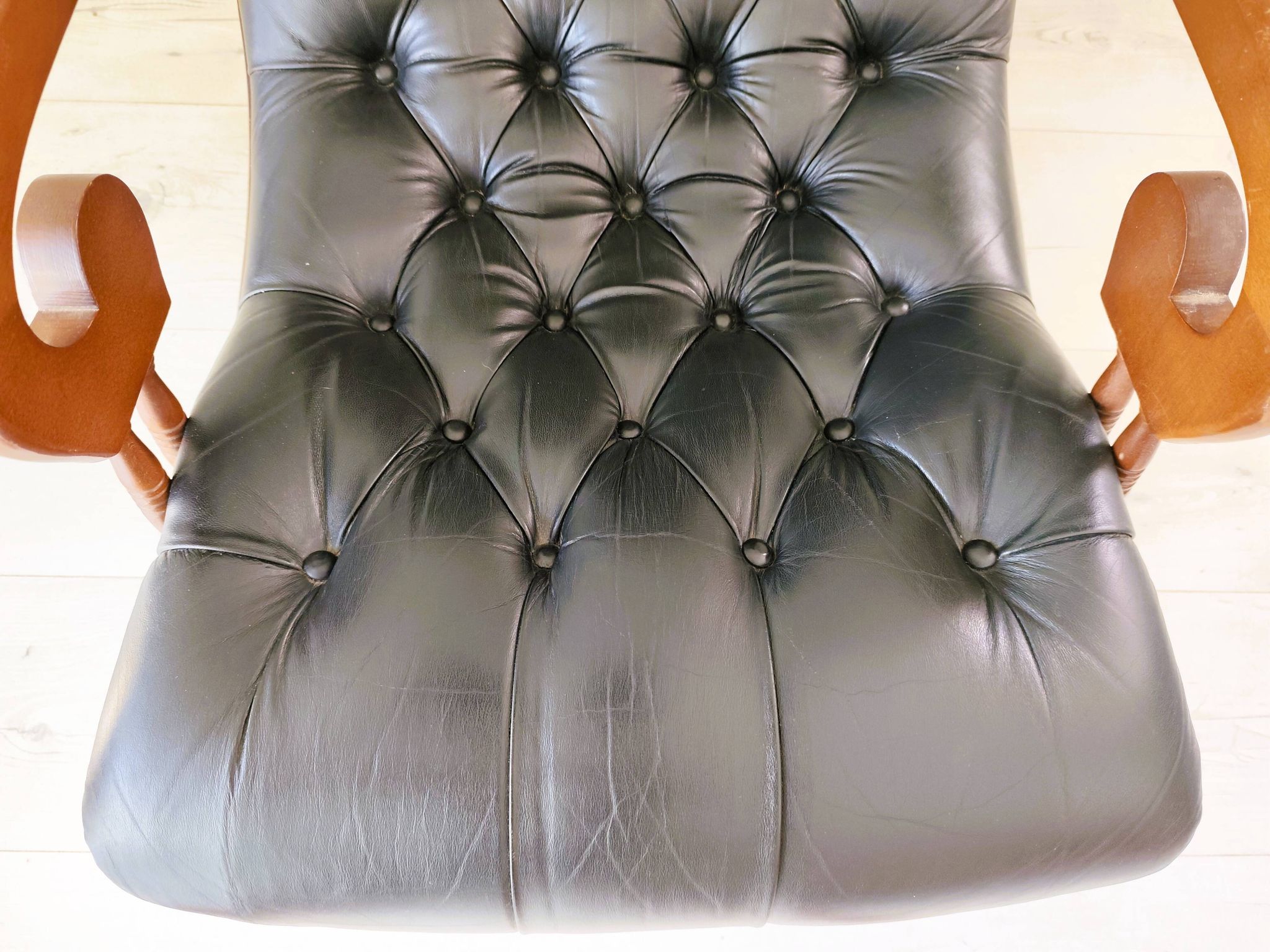 Black leather rocking Chesterfield armchair