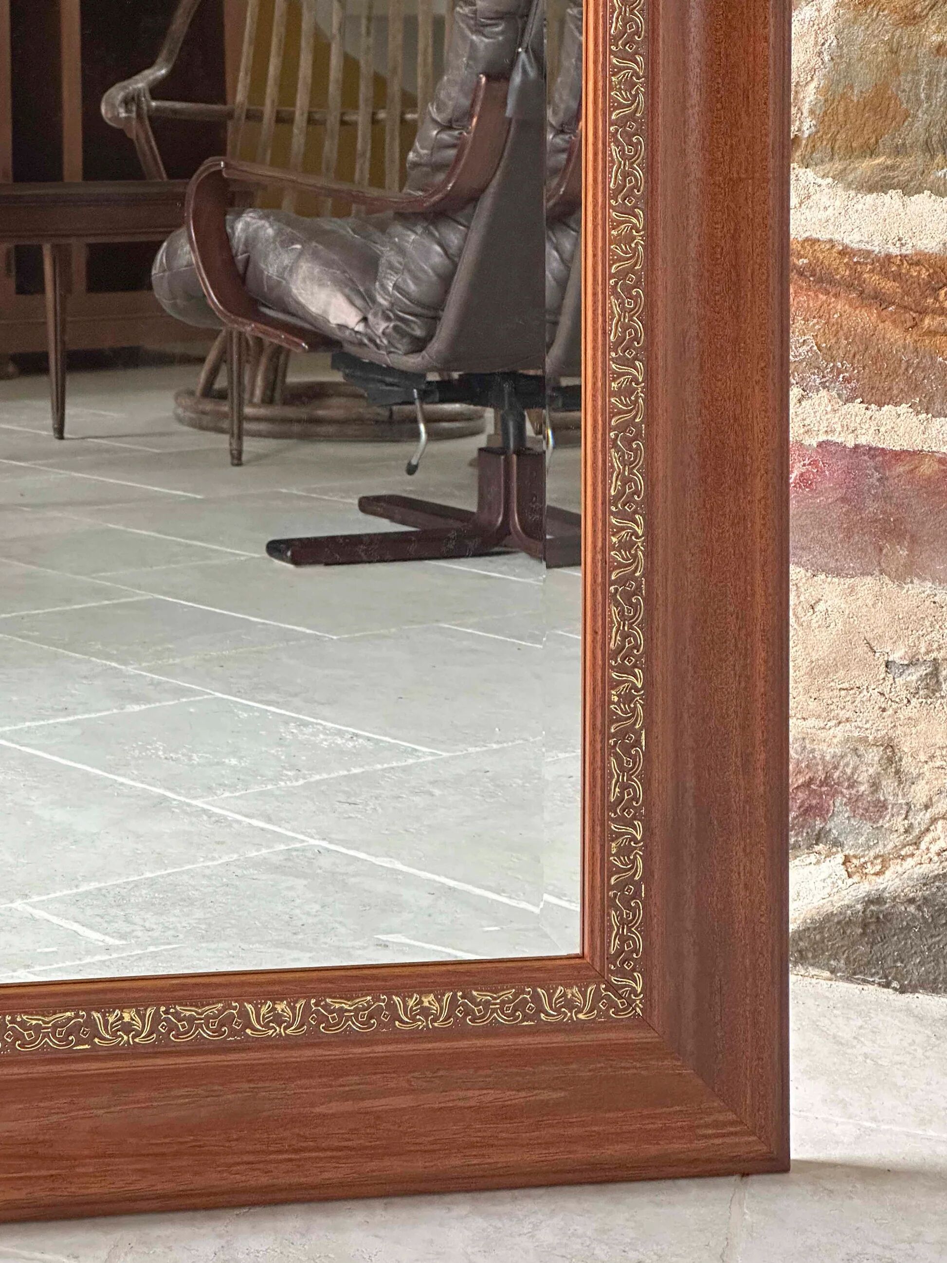 Large bevelled tabletop mirror in carved gilded wood.