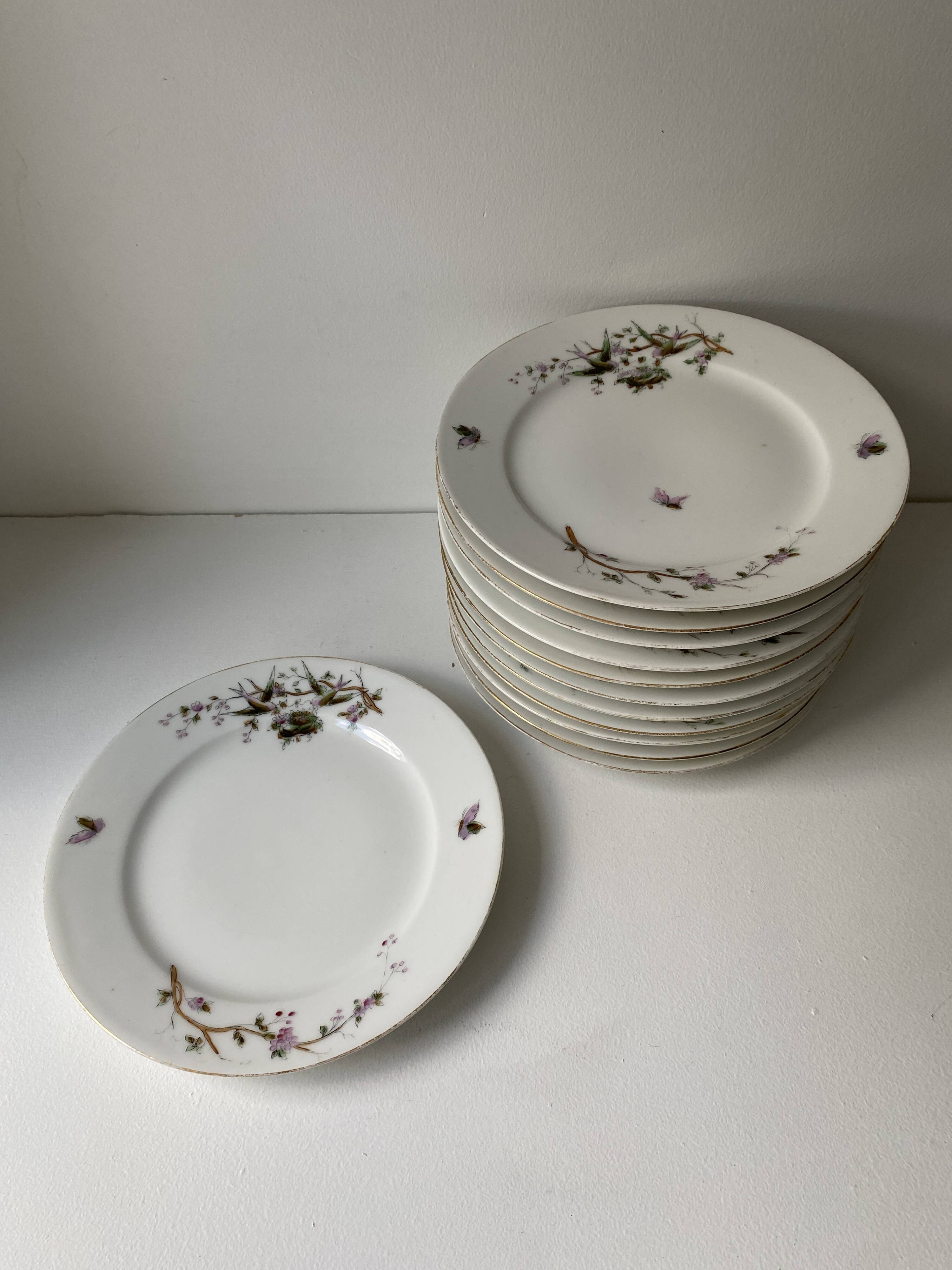 12 vintage porcelain dessert plates signed hache, julien & cie birds