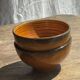 Pair of small orange bowls with black edging