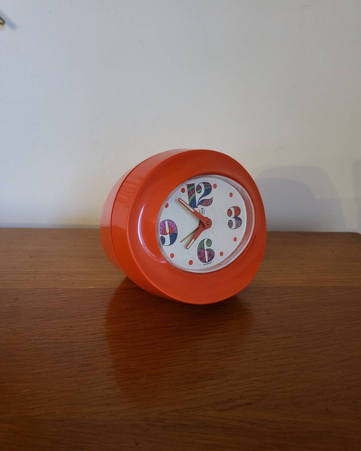 Vintage mechanical alarm clock in orange plastic Uti West Germany
