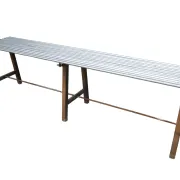 Long metal bench with tubular seat