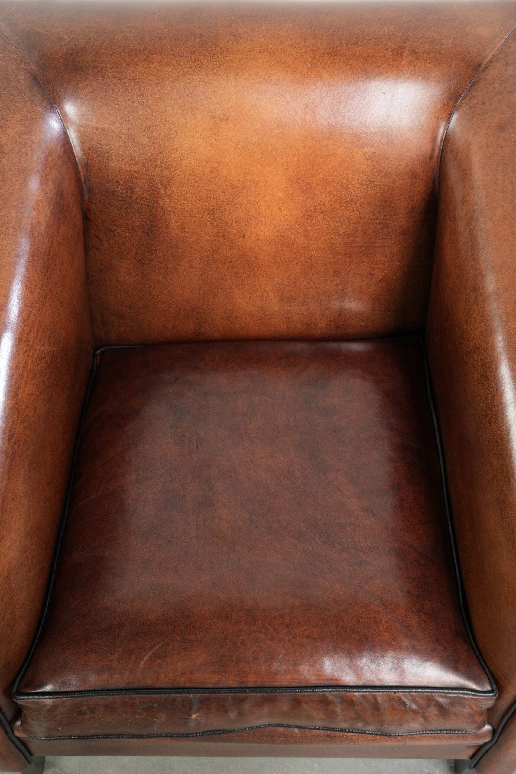 Sleek sheepskin Art Deco design armchair with black piping